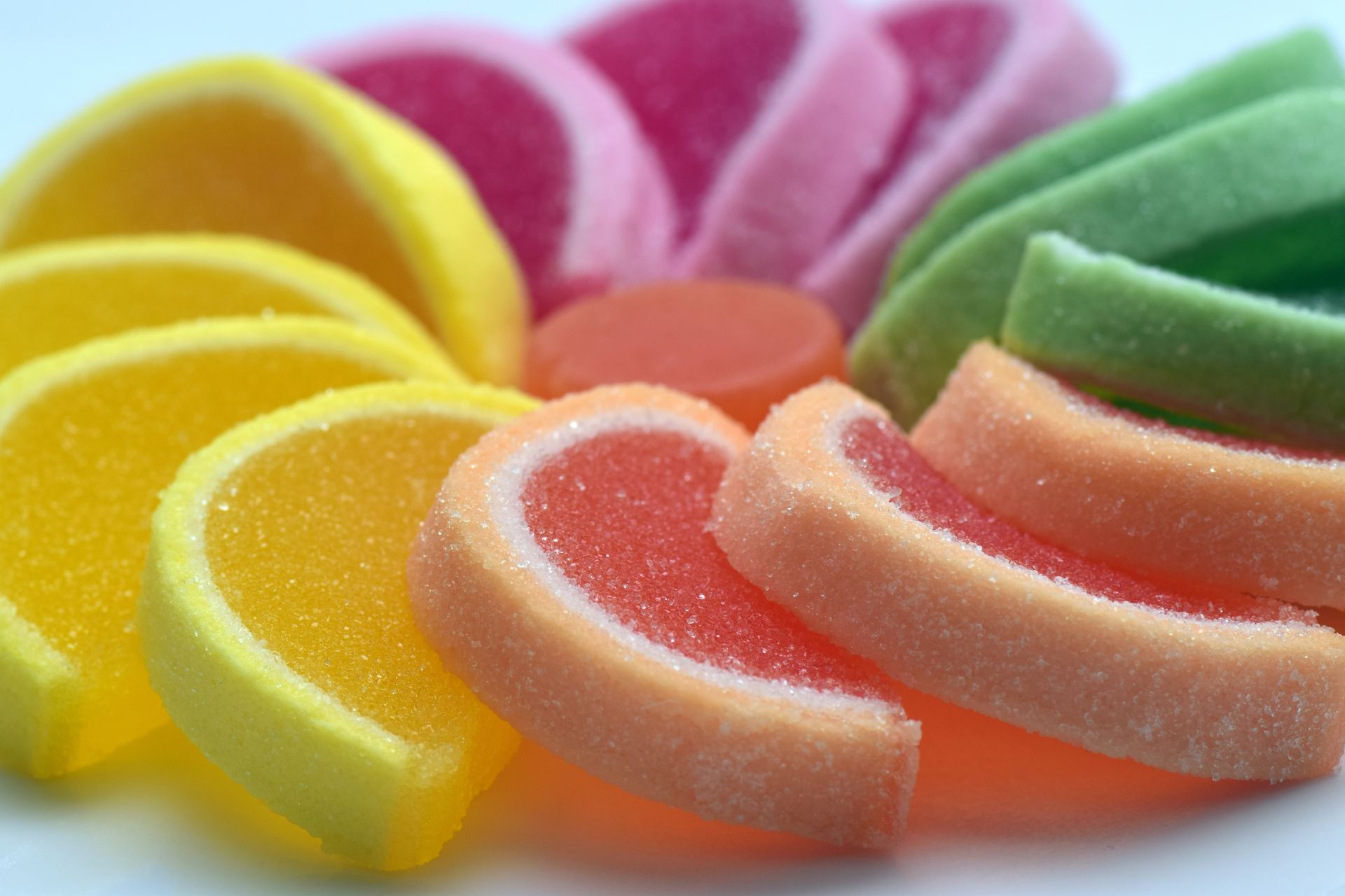 Colorful sugar-coated Swedish fruit slice candies in lemon, pink, orange and green